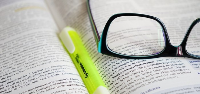 glasses on an open university course book